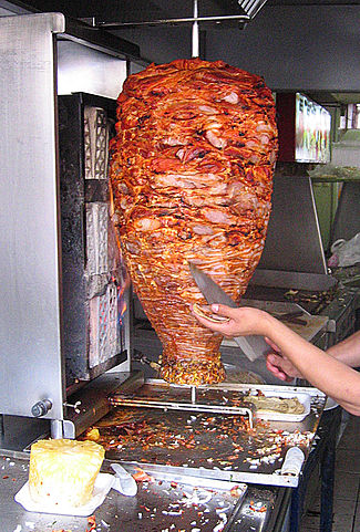 cooking tacos al pastor on grill