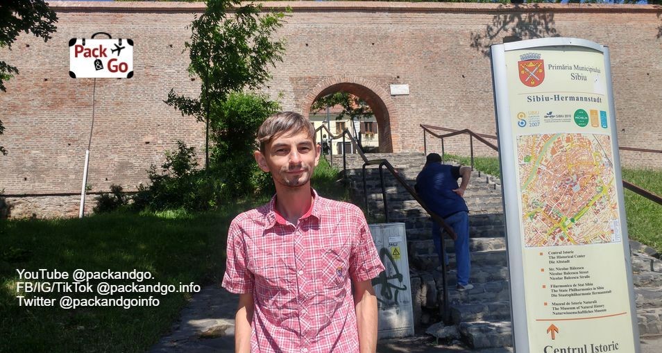 Man in front of fortress wall, Sibiu, Romania